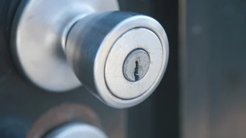 Apartment security gate handle unlocked by keys in neighborhood Stock Footage 89231010