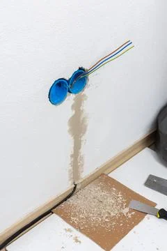 Apartment wall preparation for electrical outlets includes blue conduit box.. Stock Photos