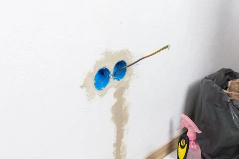 Apartment wall preparation for electrical outlets includes blue conduit box.. 写真素材