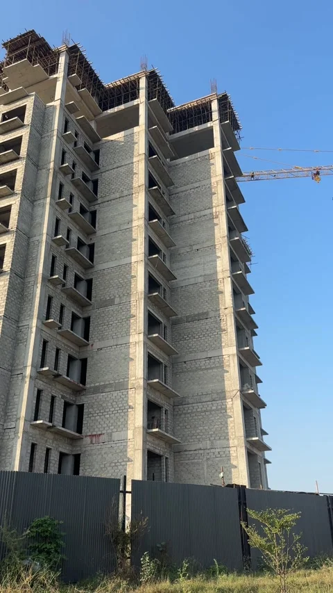 Apartments under construction with a crane. Construction site with a crane. Stock Footage 296887412