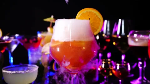 Aperol spritz drink with dry ice smoke effect at bar counter, bartender show. Stock Footage 142532663