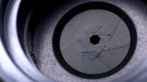 Aperture or iris mechanism in rotation. Camera lens aperture close up. Stock Footage 99375197