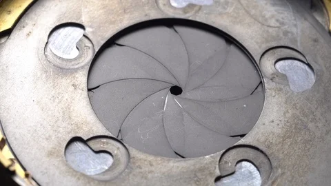 Aperture or iris mechanism in rotation. Camera lens aperture close up. Concep Stock Footage 99636450