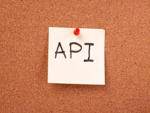 API written on a sticky note on a cork board Stock Photos