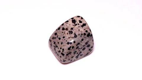 Aplite arfvedsonite dalmatian tumbled stone isolated white background Stock Footage 338068639