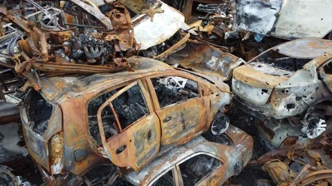 Apocalyptic background with broken vehicle. Burned cars body. Stock Footage 303081689