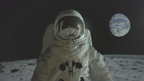 Apollo 11 astronaut on the moon surface with earth in the background. 動画素材 152718312