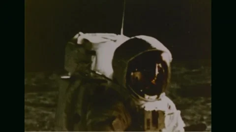 Apollo 11 astronaut walking on moon's surface Stock Footage