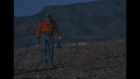 Apollo 14 Astronaut Alan Shepard pre-launch geology training at volcanic site Stock Footage 274336204