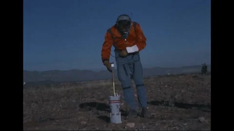Apollo 14 Astronaut Alan Shepard pre-launch geology training at volcanic site Stock Footage 274336205