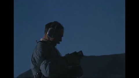 Apollo 14 Astronaut Edgar Mitchell training with video camera at volcanic site Stock Footage 274336025