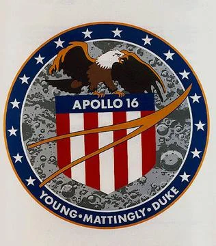 The Apollo 16 crew patch is dominated by an eagle perched atop a red, whit... Fotos de archivo