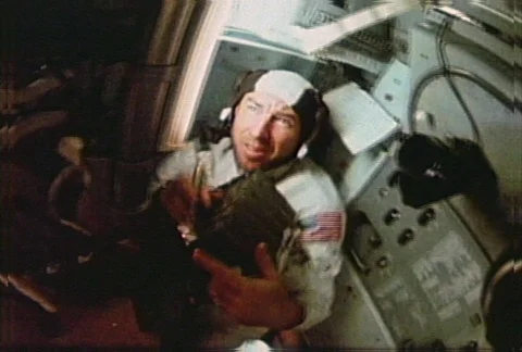 Apollo 8 - Lovell in interior using flashlight and duct tape Stock Footage 86885617