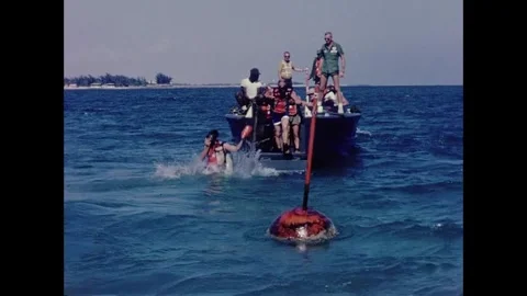 Apollo Space Program astronauts jumping off boat for scuba diving training Stock Footage 263453118
