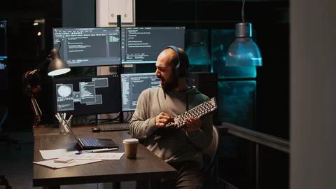 App developer playing air guitar in coding office Stockfoto's