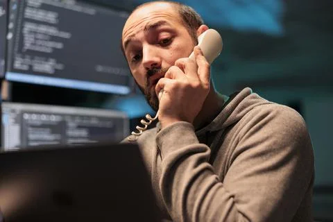 App developer talking on landline phone call Stock Photos
