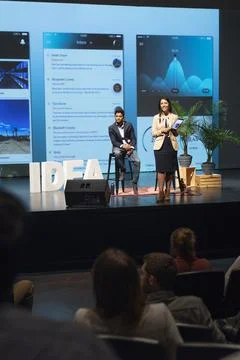 App development speakers with digital tablet on stage Stock Photos