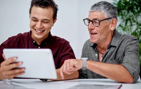 This app has been quite handy for us. two businessmen working together on a Stock Photos