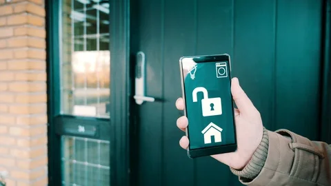 App on mobile phone controls the electronic door lock in a smart home Stock Footage 102159715