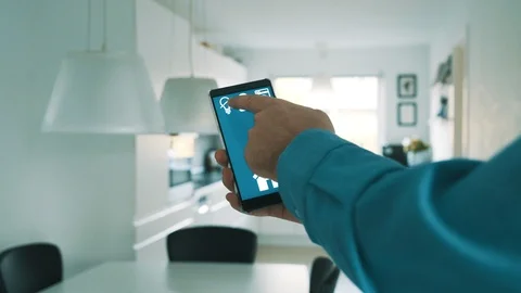 App on mobile phone controls light bulbs in smart home Stock Footage 101828896