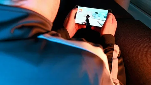 App on mobile phone shows a video game with action content Stock Footage 101080238