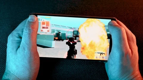 App on smart phone shows a video game with an action sequence Stock Footage 101078665