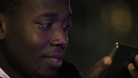 App, technology - black man amused watches a video on his smartphone - macro Stock-Footage 151513619