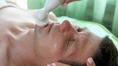 The apparatus of the brushing moves on the cheeks of a man Stock Footage 103126820