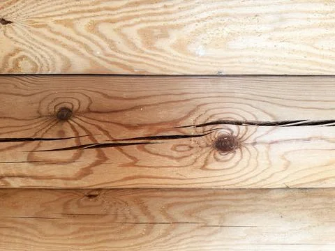 The appearance of cracks on logs during the construction of a house. Stock Photos