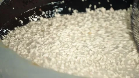 The appearance of peanuts being fried in hot oil Stock Footage 259271078