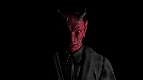 Appearance of red devil from the darkness. light from the side.  Stock Footage 227698938