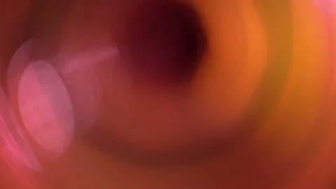 The appearance of an unfocused flash and orange light highlights on a black Stock Footage 132023381