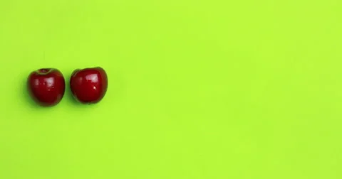 Appearing a number of red cherries from one to seven on a green background Stock Footage 52596495