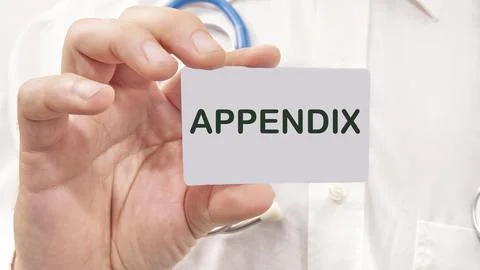 Appendix word on the card in a man's hand on the background of a white shirt Stock Photos