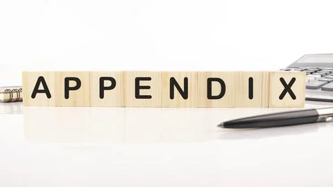 Appendix word written word assembled from wooden cubes next to a calculator.. Stock Photos