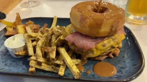 Appetising greasy burger with chips Stock Footage 313869246