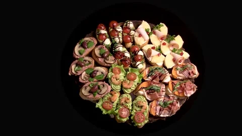 An appetizer board with various bruschetta for a buffet: jamon, ham, pate, .. Stock Footage 303300617
