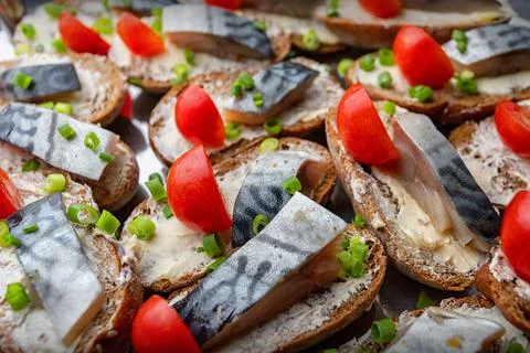 Appetizer bread with mackerel and tomatoes, close-up, selective focu Stock Photos