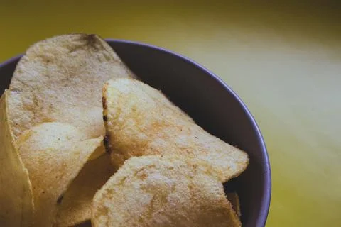 Appetizer chips on a plate close-up on a yellow background Foto stock