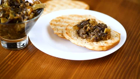 Appetizer of cooked eggplant with vegetables on bread Stock Footage 102950129