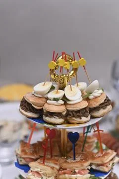 Appetizer display featuring cold finger food with decorative picks on buffet Stock Photos