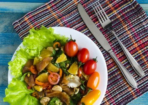 Appetizer with fish and vegetables on a white plate Stock Photos
