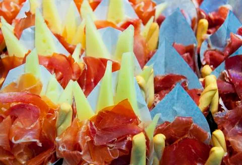 Appetizer of ham Serrano with bread roasted and accompanied Stock Photos