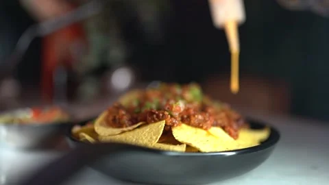 Appetizer is made by placing salad on chips Stock Footage 181017771