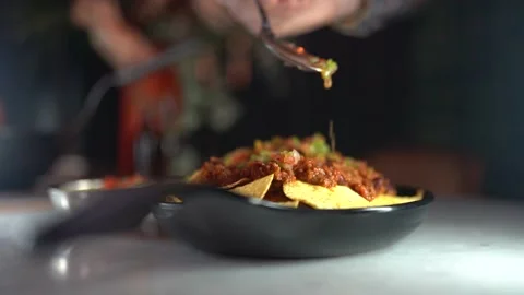 Appetizer is made by placing salad on chips Video stock 181200592