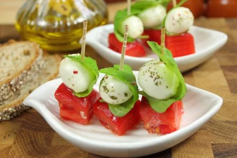 Appetizer with mozzarella, tomato and basil. Stock Photos