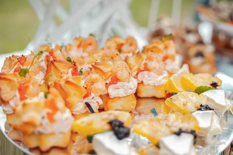 Appetizer pineapple with camembert and pine nuts Stock Photos