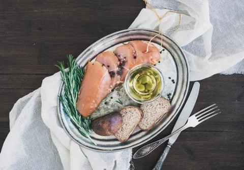 Appetizer set: chicken carpaccio, bread, olives, spices and rose Stock Photos