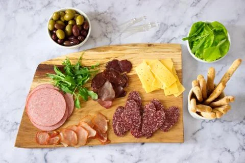 Appetizer table for wine or beer with sausages, dried meat and cheese, served Stock Photos