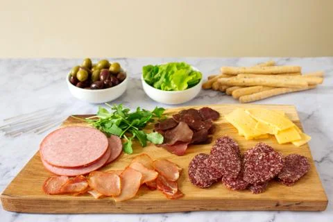 Appetizer table for wine or beer with sausages, dried meat and cheese, served Stock Photos